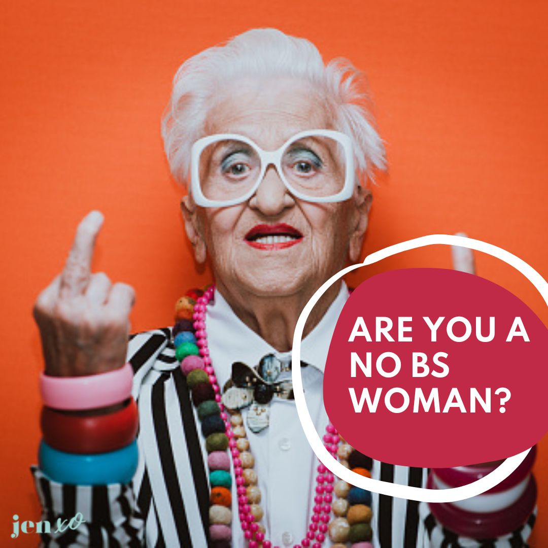 A very colorful older woman flipping off the camera against an orange background with a pink circle and the words Are You A No BS Woman?